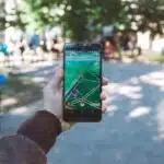 , person playing Pokemon Go during daytime
