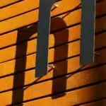 , black metal frame on brown wooden wall