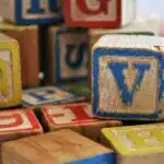 These colorful, scuffed blocks are part of a collection I purchased from a sweet elderly couple who kept them in a box for their grandchildren. Their grandchildren long-grown, they were happy to share them with me., assorted-color alphabet cube toy lot