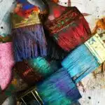 Florida Artist RhondaK paintbrushes drying. She uses colorful paint in her works on mermaids, manatees, crabs, palm trees, and more. RhondaK.art, assorted-color paintbrushes