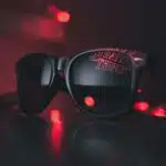 Stranger things, black wayfarer sunglasses on black surface