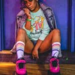 skating thank you so much can you check out the link https://soundcloud.com/search?q=12horse3vm, woman sitting wearing roller skates and jacket while holding lollipop