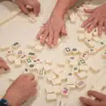 , person playing white and brown lego blocks