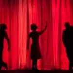 My brother recently landed a feature role in an amateur theatre production of “Singing In The Rain”. Despite what the title infers - there is nothing amateur about it. Production value is high, and the acting takes you out of the auditorium and into your own magical sing-song world. Needless to say - a very proud brother right here., silhouette of three performers on stage